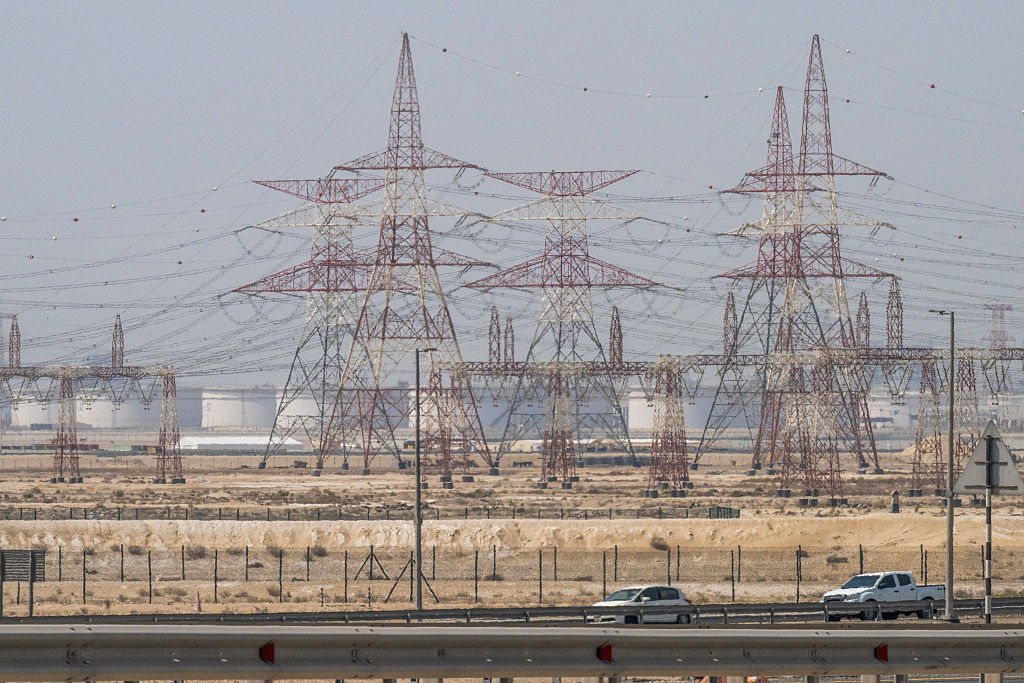 Motorists drive past an ADNOC Gas facility, a subsidiary of the Abu Dhabi National Oil Company, in Abu Dhabi on March 3, 2026. The war launched by the United States and Israel against Iran spread across the Middle East, threatening to plunge the global economy into chaos, with Lebanon and Gulf energy exporters dragged into the conflict. 