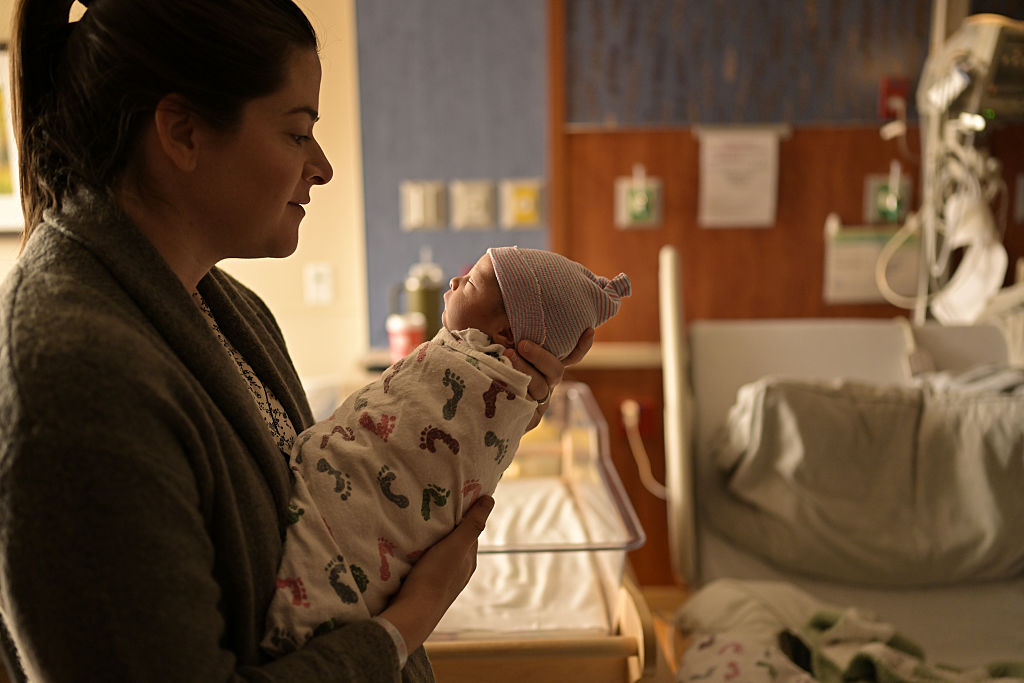 A mother lulls her newborn baby at Saint Joseph Hospital in Denver, Colorado on April 1, 2025.