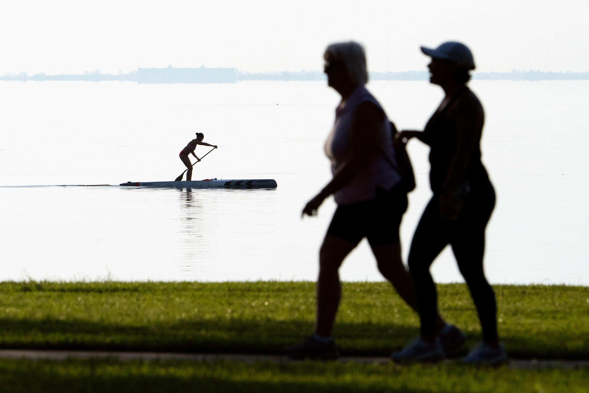 Women walking near water.