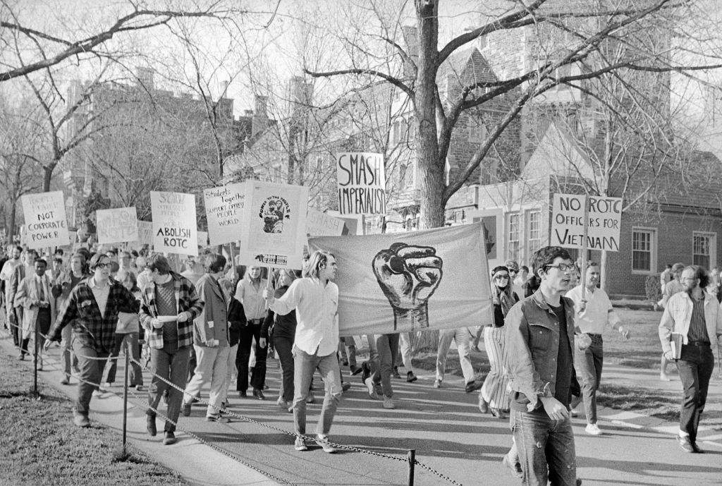 In this black and white photo taken on campus, students at Princeton University march with signs to protest war and the R.O.T.C. on April 25, 1969.
