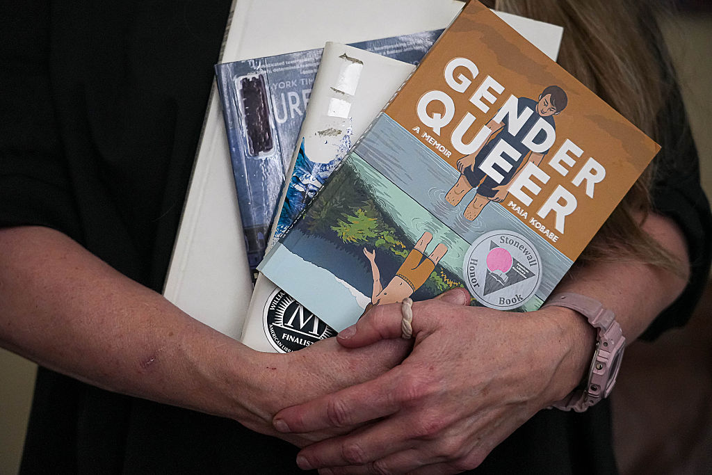 Suzette Baker, former head librarian at the Kingsland Branch Library in the Llano County Library System, holds some banned books at the Edwards Law office on Monday, Mar. 4, 2024 in Austin.