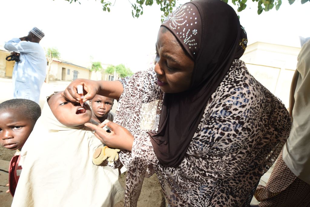 UNICEF health consultant Hadiza Waya immunizes a child during vaccination campaign against polio at Hotoro-Kudu, Nassarawa district of Kano in northwest Nigeria, on April 22, 2017.